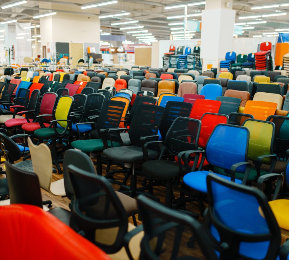 Rows of different office chairs in furniture store showroom, nobody. Comfort seats samples in shop, goods for modern interior